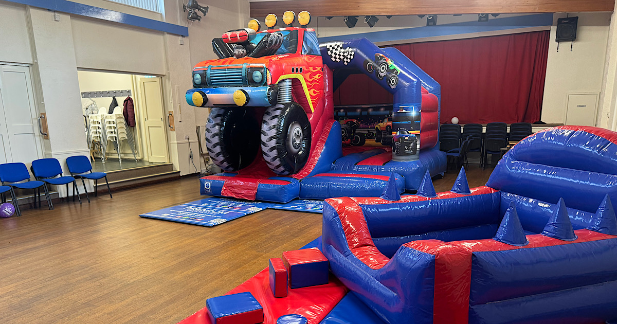 Monster truck themed inflatable and soft play setup at Cookridge Village Hall for kids birthday party